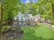Beautiful exterior view of a home with a large backyard, spacious deck, and serene surroundings at 7530 Heard Rd, Cumming, GA 30041