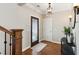 Elegant foyer with hardwood floors, decorative lighting, and a beautifully designed front door at 7530 Heard Rd, Cumming, GA 30041