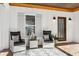 Inviting front porch featuring comfortable seating, stylish decor, and a charming entrance at 7530 Heard Rd, Cumming, GA 30041
