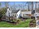 Exterior shot of the house featuring a deck, patio, backyard and lake views at 7530 Heard Rd, Cumming, GA 30041