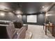 Home theater featuring plush seating and a large screen at 7530 Heard Rd, Cumming, GA 30041