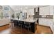 Modern kitchen with white cabinets, granite countertops, stainless steel appliances, and a large island with seating at 7530 Heard Rd, Cumming, GA 30041