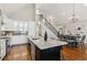 Spacious kitchen with granite island, stainless appliances, pendant lighting, and adjoining dining area at 7530 Heard Rd, Cumming, GA 30041