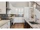 Stylish kitchen with stainless steel appliances, granite counters, and cabinetry with glass fronts at 7530 Heard Rd, Cumming, GA 30041