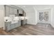 Spacious kitchenette with gray cabinets, a farmhouse sink, and hardwood floors, perfect for entertaining at 7530 Heard Rd, Cumming, GA 30041