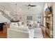 Expansive living room featuring a stone fireplace, hardwood floors, and an open layout connecting dining area and staircase at 7530 Heard Rd, Cumming, GA 30041