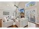 Bright living room with fireplace, hardwood floors, ceiling fan and sliding glass doors leading to outdoor deck at 7530 Heard Rd, Cumming, GA 30041