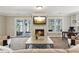 Relaxing living room with fireplace, lake views, and access to outdoor seating at 7530 Heard Rd, Cumming, GA 30041