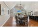 Open-concept living space with hardwood floors, fireplace, and abundant natural light from large windows at 7530 Heard Rd, Cumming, GA 30041