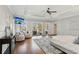 Spacious primary bedroom with a tray ceiling, hardwood floors, stylish seating, and access to an outdoor deck at 7530 Heard Rd, Cumming, GA 30041