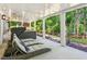 Spacious patio with lounge chairs, a hot tub, and views of the landscaped backyard and lake at 7530 Heard Rd, Cumming, GA 30041