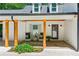 Charming porch with stone flooring, wood columns, and cozy seating creating a welcoming and inviting outdoor space at 7530 Heard Rd, Cumming, GA 30041