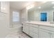 Bright bathroom with double sink vanity, large mirror, soaking tub, and neutral walls at 1012 Rohner Way, Smyrna, GA 30080