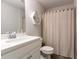 Well-lit bathroom with single sink vanity, large mirror, and shower-tub combo at 1012 Rohner Way, Smyrna, GA 30080