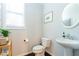 Charming powder room with pedestal sink, decorative mirror and soft lighting at 1012 Rohner Way, Smyrna, GA 30080