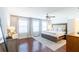 A bedroom with a neutral palette, three windows, and a light-colored wood floor at 1012 Rohner Way, Smyrna, GA 30080