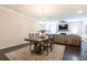 Open-concept dining room and living room showcasing dark wood floors and neutral tones at 1012 Rohner Way, Smyrna, GA 30080