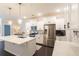 Modern kitchen with white cabinets, quartz countertops, stainless steel appliances, and dark hardwood floors at 1012 Rohner Way, Smyrna, GA 30080