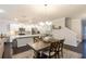 Bright kitchen and dining area featuring white cabinets, stainless steel appliances, and an elegant chandelier at 1012 Rohner Way, Smyrna, GA 30080