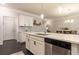 Kitchen island with sink, stainless steel dishwasher, and modern white cabinetry at 1012 Rohner Way, Smyrna, GA 30080