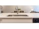 Close-up of a kitchen island with white countertop and view of the dining room at 1012 Rohner Way, Smyrna, GA 30080