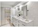 Modern bathroom with double sinks, white cabinets, and subway tile offers a clean and functional space at 1054 Club Ne Pl, Atlanta, GA 30319