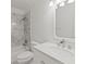 Bright bathroom featuring modern vanity, fixtures, tub and shower combination with elegant marble tiling at 1054 Club Ne Pl, Atlanta, GA 30319