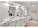 Elegant bathroom with double vanity, subway tile, and freestanding tub exudes sophistication and relaxation at 1054 Club Ne Pl, Atlanta, GA 30319