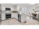 Well-lit kitchen with white cabinets, stainless steel appliances, and eat-in breakfast nook at 1054 Club Ne Pl, Atlanta, GA 30319