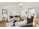 Open-concept living room with hardwood floors, modern chandelier, and neutral-toned furniture at 1054 Club Ne Pl, Atlanta, GA 30319