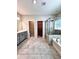 Bathroom with double sink vanity, tiled floor, tub, and glass shower at 4316 Waxwing St, Buford, GA 30548