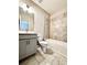 Modern bathroom with gray vanity, tiled floor, and shower-tub combo at 4316 Waxwing St, Buford, GA 30548