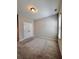 An empty bedroom has neutral paint, carpet, and a double door closet at 4316 Waxwing St, Hoschton, GA 30548