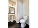 Cozy half bathroom featuring pedestal sink, modern lighting, and stylish decor at 4316 Waxwing St, Hoschton, GA 30548