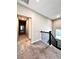 Carpeted hallway with black metal railing and view of windows at 4316 Waxwing St, Hoschton, GA 30548