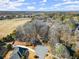 Aerial view showcasing the property's expansive lot, mature trees, and proximity to nearby community amenities at 6170 Wellington Ct, Cumming, GA 30040