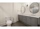 Bathroom with double vanity, gray cabinetry and contemporary lighting at 6170 Wellington Ct, Cumming, GA 30040