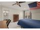 Inviting bedroom with a blue quilt bed, wood dresser, and a view to a private outdoor balcony at 6170 Wellington Ct, Cumming, GA 30040