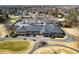 Aerial shot of the golf course clubhouse with ample parking, golf cart staging, and a meticulously manicured lawn at 6170 Wellington Ct, Cumming, GA 30040