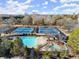 Aerial view of the community featuring a large pool and tennis courts creating a recreational space for residents and families at 6170 Wellington Ct, Cumming, GA 30040