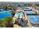 Overhead view of the community pool area with a pool house and tennis courts offering a variety of recreational activities at 6170 Wellington Ct, Cumming, GA 30040