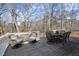 Open wood deck with dining table and seating, perfect for outdoor gatherings and enjoying the serene natural surroundings at 6170 Wellington Ct, Cumming, GA 30040