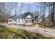 Expansive single-story home showcases a long driveway, lush lawn, and meticulously landscaped surroundings at 6170 Wellington Ct, Cumming, GA 30040