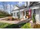 Inviting front entrance with a wooden door, stone walkway, and well-maintained landscaping at 6170 Wellington Ct, Cumming, GA 30040