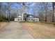 Charming single-story home featuring a black roof, white siding, and a well-manicured front yard at 6170 Wellington Ct, Cumming, GA 30040