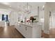 Well-lit kitchen featuring a central island, modern lighting, and open layout at 6170 Wellington Ct, Cumming, GA 30040