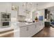 Modern kitchen featuring white cabinetry, stainless steel appliances, large island and decorative lighting at 6170 Wellington Ct, Cumming, GA 30040