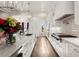 Bright kitchen featuring white cabinets, an island, and stainless steel appliances at 6170 Wellington Ct, Cumming, GA 30040