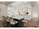 Spacious kitchen with island seating, designer lighting, and seamless flow into the hallway at 6170 Wellington Ct, Cumming, GA 30040