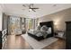 Spacious main bedroom with hardwood floors, a ceiling fan, and large windows offering natural light at 6170 Wellington Ct, Cumming, GA 30040